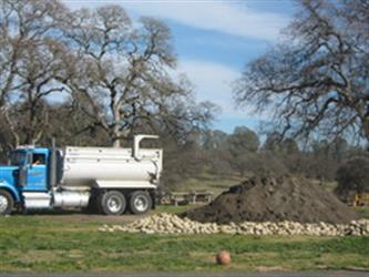 truck leaving a pile of dirt and rocks