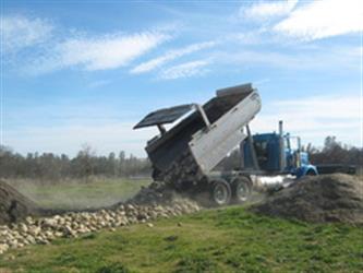 dumpster dumping rocks